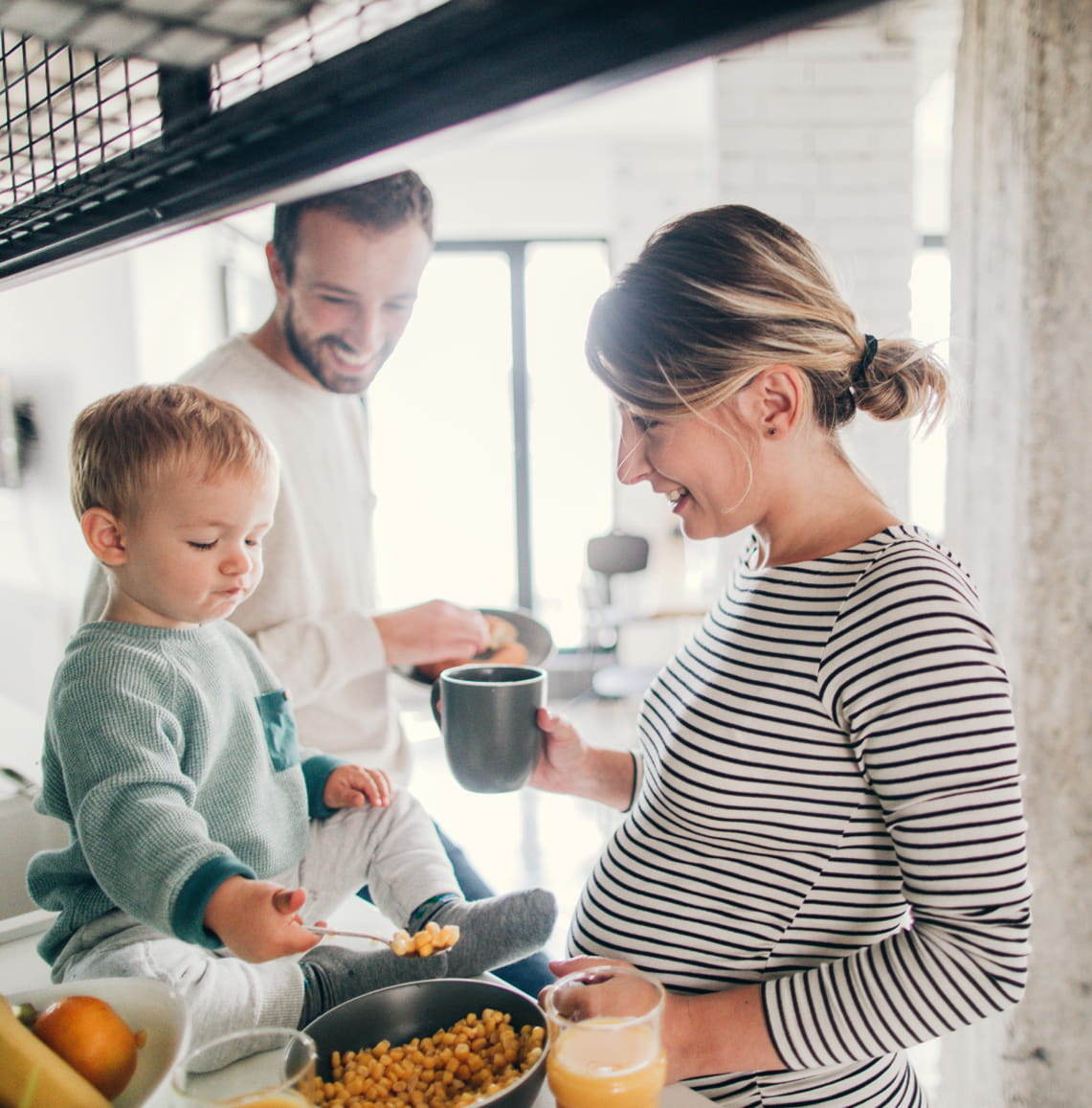 Photo of a young family preparing breakfast together in their kitchen